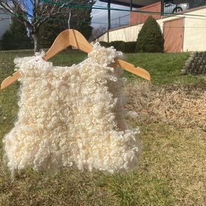 Size small 15” across  back and 12” long. Natural cream sheared wool locks